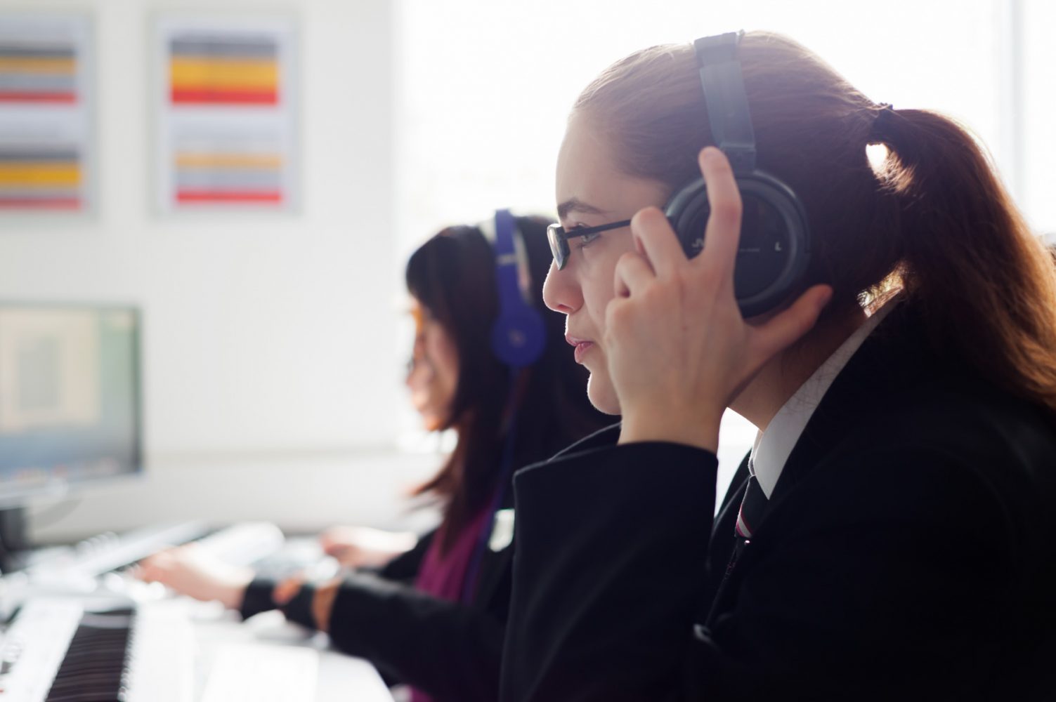 Academy school website photography of pupils wearing headphones