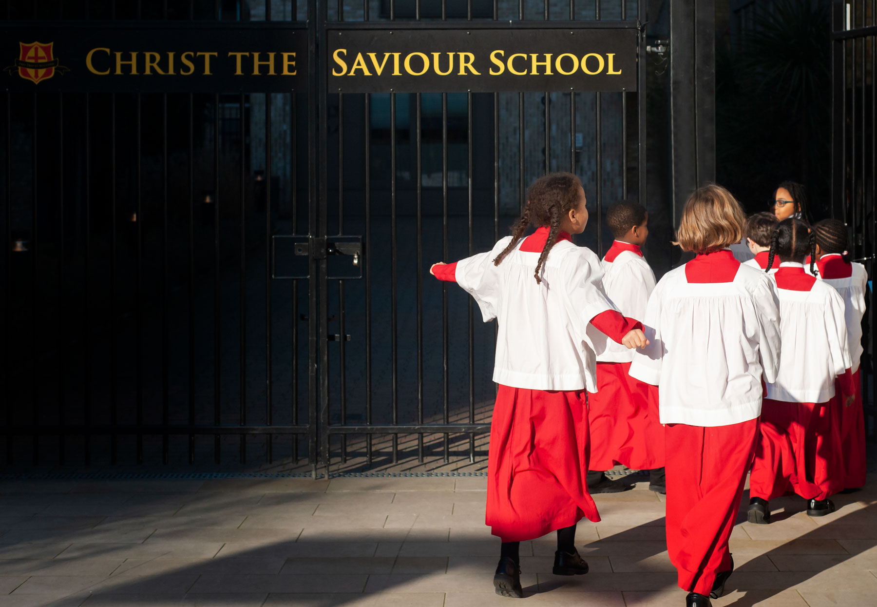 Primary school website photogrpahy of school choir returning through school gates